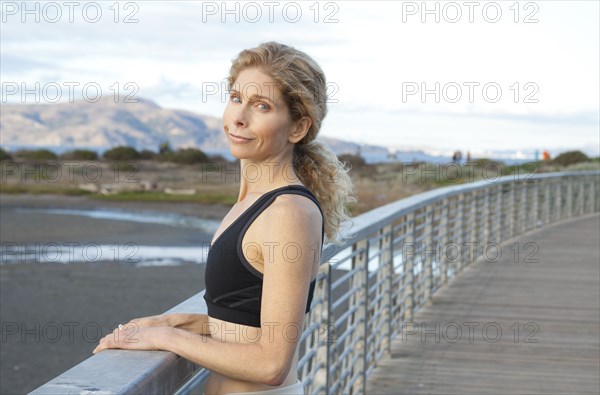 Caucasian woman standing on footbridge
