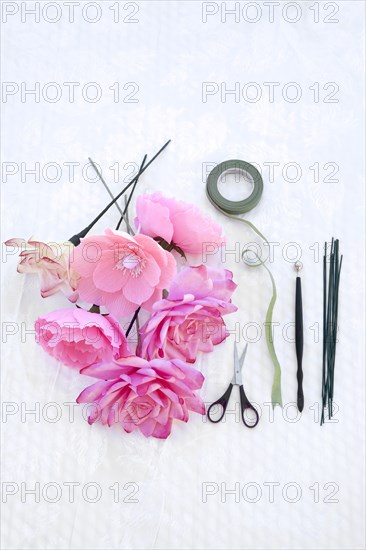 Fake flowers with tape and scissors