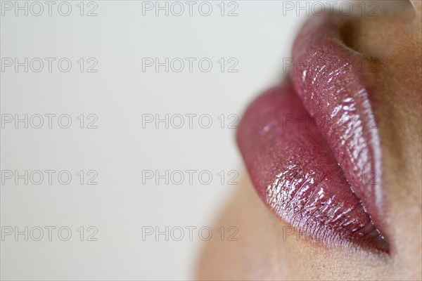 Close up of woman wearing lip gloss