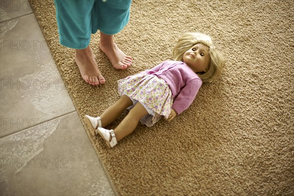 High angle view of teenage girl standing over doll