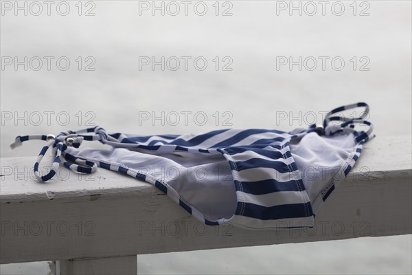 Close up of bikini bottoms drying on banister