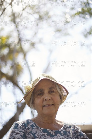 Smiling older woman sitting outdoors