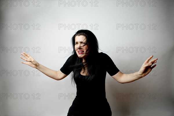 Confused Caucasian woman shrugging