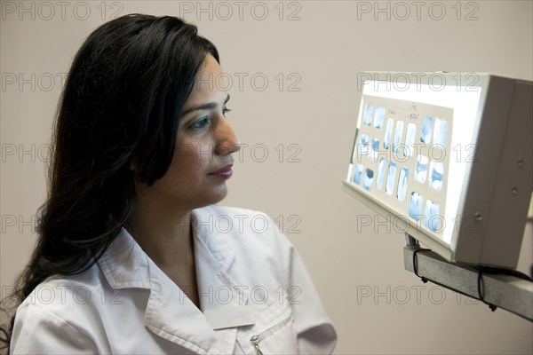 Indian dentist examining x-rays