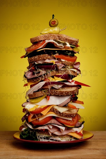 Oversized stacked deli sandwich on plate