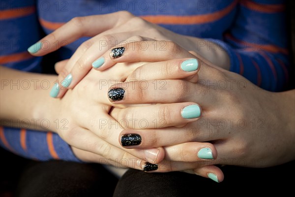 Close up of women holding hands