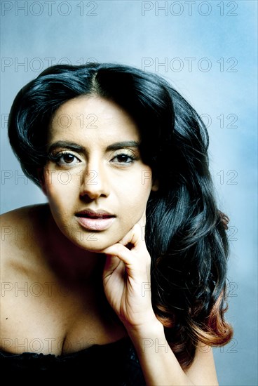 Indian woman resting chin in hand