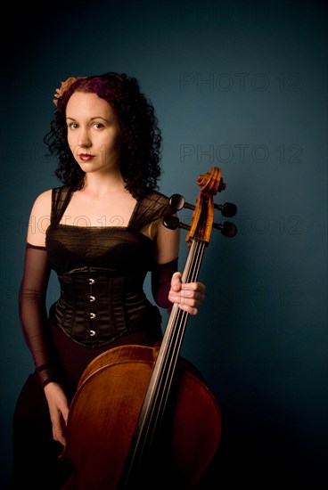 Serious musician holding cello