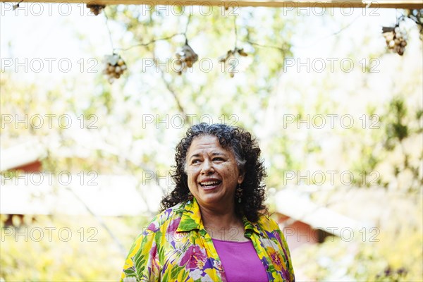 Hispanic woman smiling in backyard