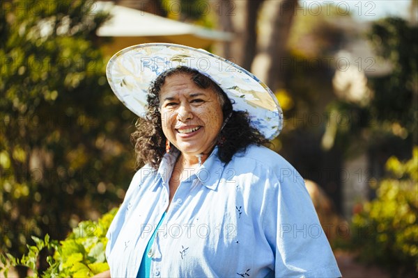 Hispanic woman smiling in backyard