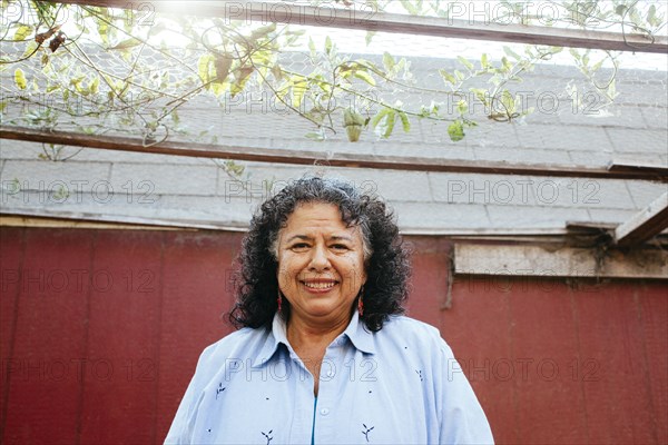 Hispanic woman smiling under transparent roof