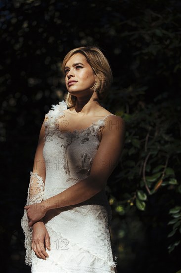 Bride wearing wedding gown in garden