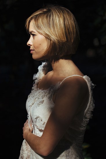 Bride wearing wedding gown in garden