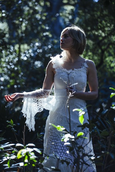 Bride wearing wedding gown in garden