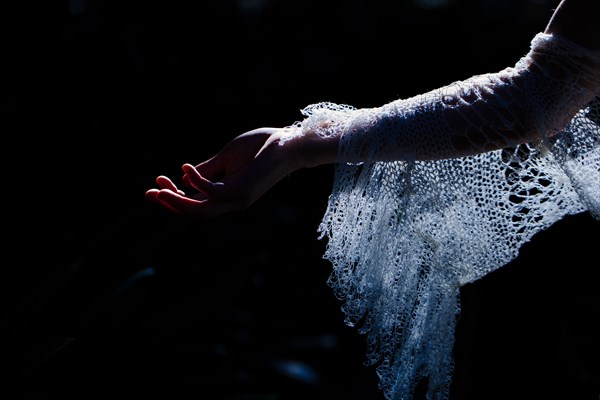 Close up of bride wearing lace sleeve