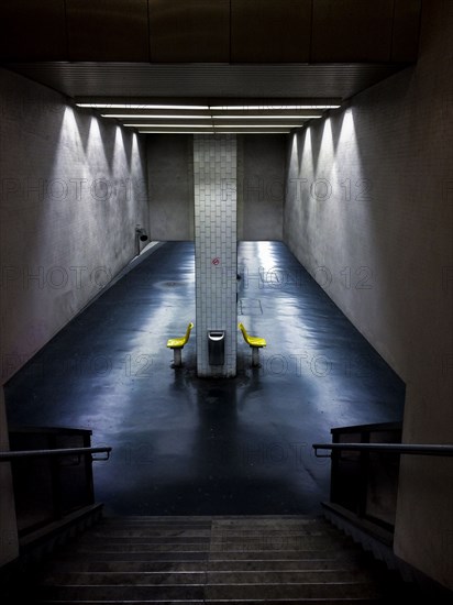 Empty chairs in urban underground tunnel