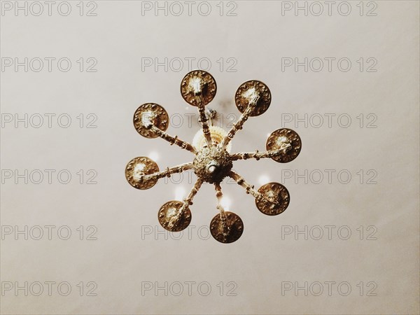 Low angle view of chandelier hanging from ceiling