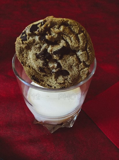 Close up of cookie in glass of milk