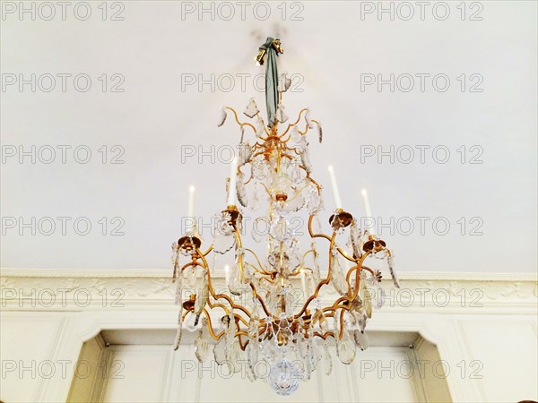 Low angle view of chandelier hanging from ceiling