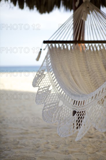 Close up of hammock hanging on tropical beach