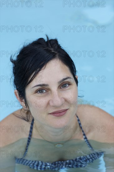Smiling woman swimming in pool