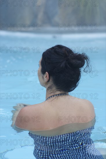 Rear view of woman swimming in pool