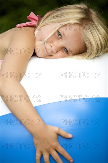 Close up of girl hugging beach ball