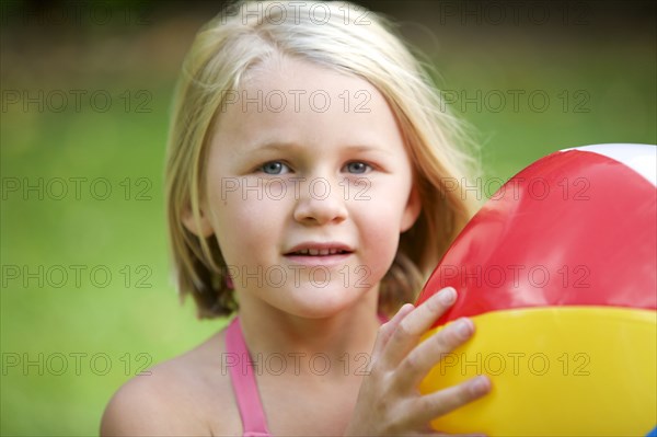 Close up of girl holding beach ball