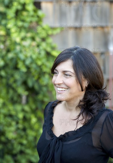 Close up of smiling woman in backyard