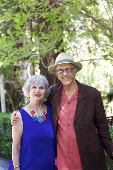 Older couple hugging in backyard