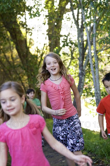 Children running on dirt path in park