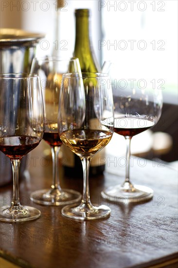 Glasses of red and white wine on table