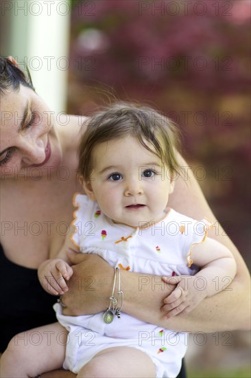 Close up of mother holding baby daughter