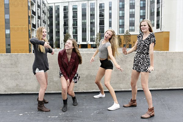 Teenage girls posing on urban rooftop