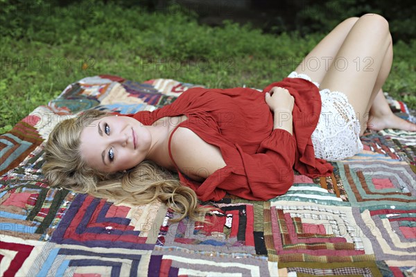 Teenage girl laying on blanket