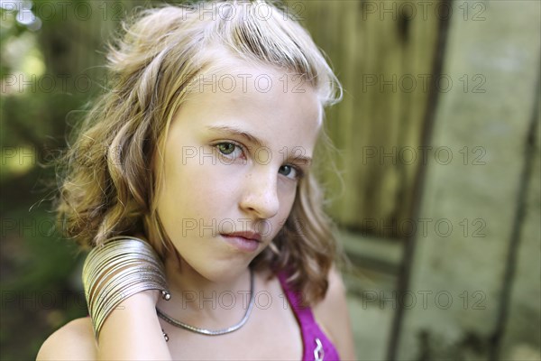 Close up of serious girl standing outdoors