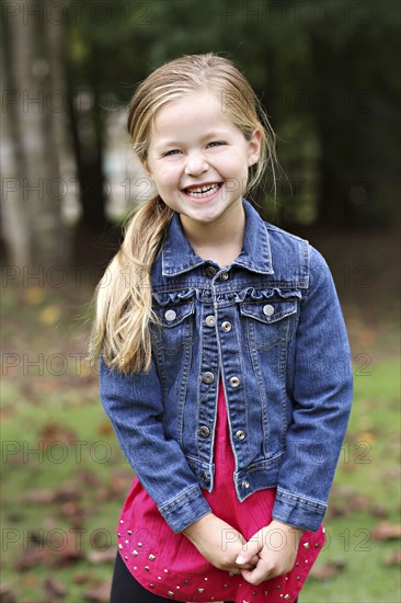 Smiling girl standing in rural field