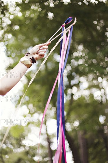 Low angle view of girl playing with ribbons outdoors