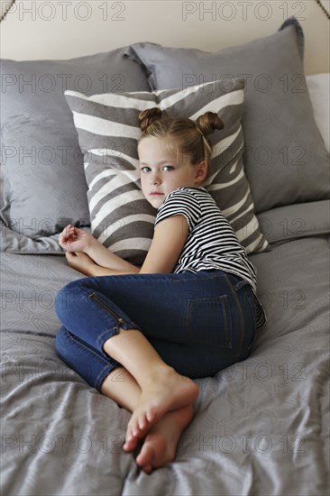 High angle view of girl laying on bed