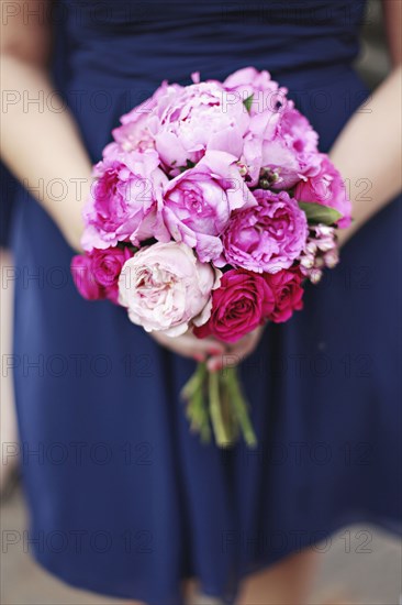 Close up of woman carrying bouquet of flowers