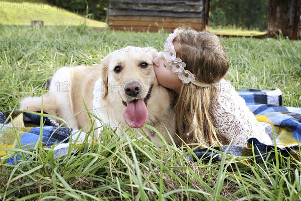 Caucasian girl laying on blanket with dog