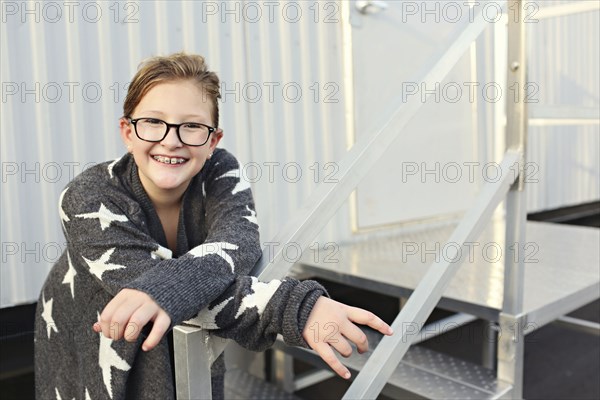 Smiling Caucasian girl standing outside trailer