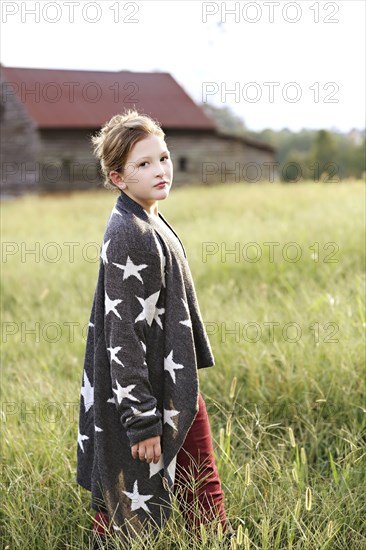 Stylish Caucasian girl walking in rural field