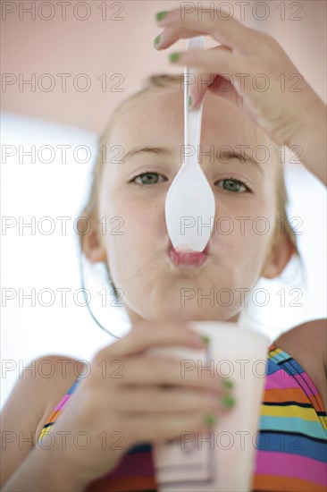 Close up of Caucasian girl eating ice cream