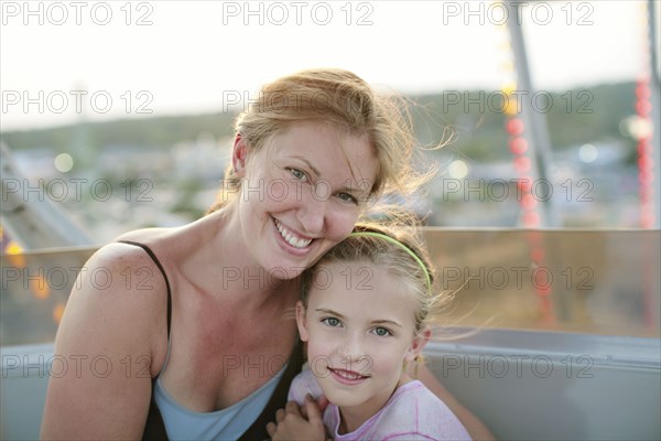 Mother and daughter hugging outdoors