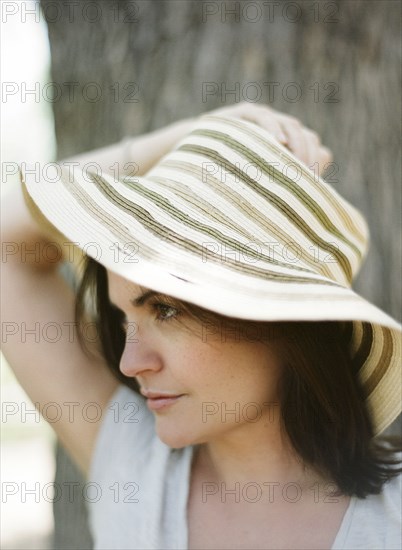 Close up of serious woman wearing sun hat