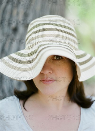 Close up of serious woman wearing sun hat