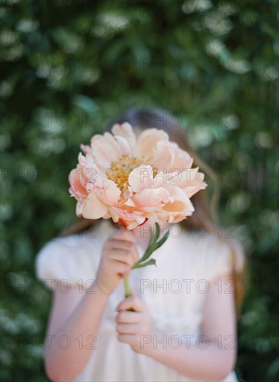 Close up of girl holding bouquet of flowers