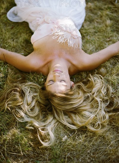 High angle view of bride laying in hay