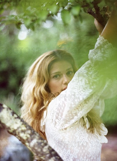 Close up of woman climbing tree